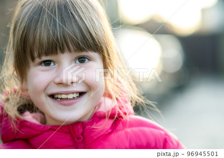 Portrait of a pretty child girl outdoors on a sunny warm autumn day. Portrait of a pretty child girl outdoors on a sunny warm autumn day. 96945501