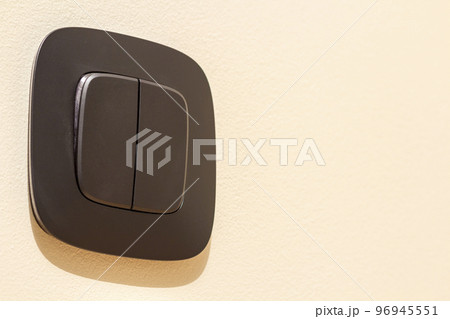 New gray electrical power outlet socket, plastic switch isolated installed on light yellow plastered wall. Home interior, electricity supply concept 96945551