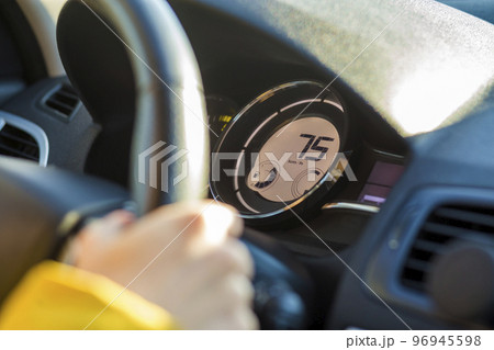 Modern car interior with driver hand on steering wheel. Safe driving concept. 96945598
