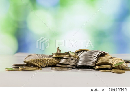 Growing coins stacks with green and blue sparkling bokeh background. Financial growth, saving money, business finance wealth and success concept. 96946546