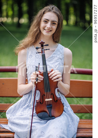 Portrait of a young girl with her violin. 96957277
