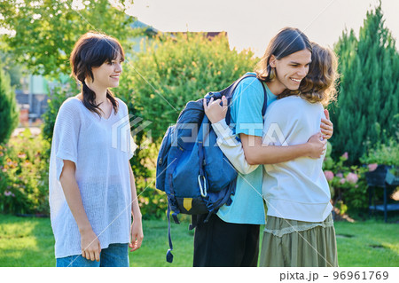 Meeting of three teenage friends, outdoor on sunny day Meeting of three teenage friends, outdoor on sunny day 96961769