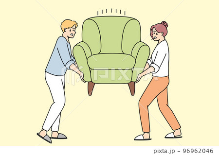 Man, woman install heavy armchair after moving. 96962046