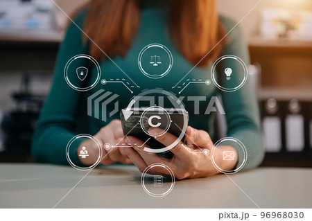 Copyright or patent concept, Person hand using laptop computer, tablet and smartphone with virtual screen copyright icon trademark, Creation ownership against piracy. Copyright or patent concept, Person hand using laptop computer, tablet and smartphone with virtual screen copyright icon trademark, Creation ownership against piracy. 96968030