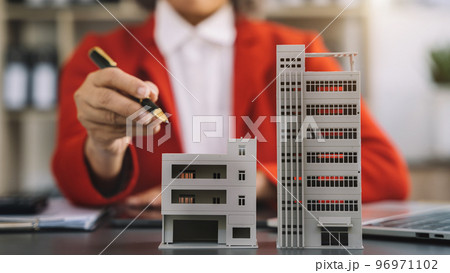 House model with agent asking costumer for contract to buy, get insurance or loan real estate or property. House model with agent asking costumer for contract to buy, get insurance or loan real estate or property. 96971102