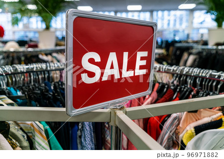 Sale Sign On Rail in Clothes Shop or Store 96971882