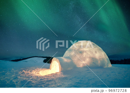 Wintry scene with glowing polar lights and snowy igloo Wintry scene with glowing polar lights and snowy igloo 96972728