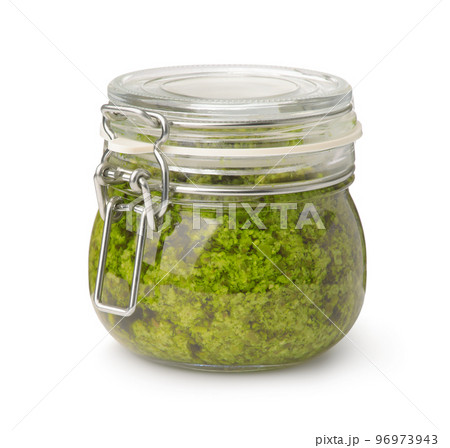 Front view of green pesto sauce in glass jar 96973943