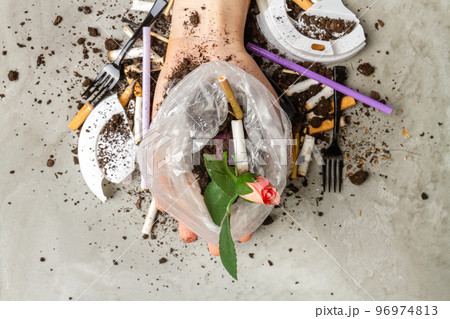 Close up hand holding plastic bag with rose flower and cigarettes. 96974813