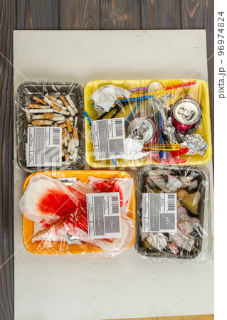 Top view flat lay waste sorting concept. Various types of waste wrapped in containers. 96974824