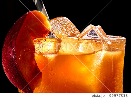 Fruit healthy cocktail from mango juice and ice on black background Fruit healthy cocktail from mango juice and ice on black background 96977358