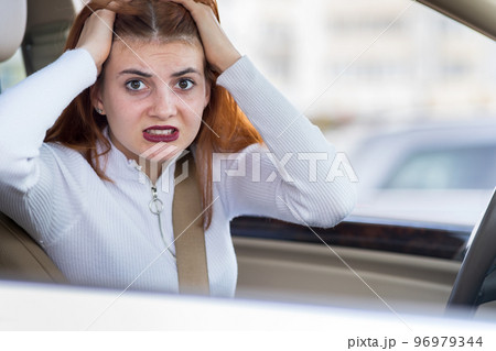 Closeup portrait of pissed off displeased angry aggressive woman driving a car shouting at someone. Negative human expression consept. 96979344