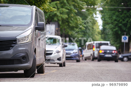 City traffic with cars parked in line on street side 96979890