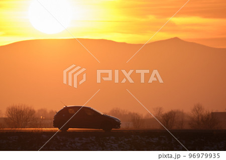 Car driving fast on intercity road at sunset. Highway traffic in evening Car driving fast on intercity road at sunset. Highway traffic in evening 96979935