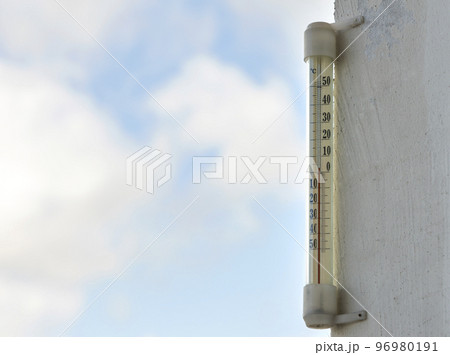 Alcohol glass thermometer Celsius outside on bright blurred light outdoors copy space background. Alcohol glass thermometer Celsius outside on bright blurred light outdoors copy space background. 96980191