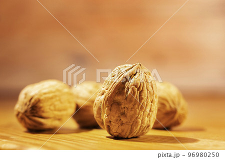 Walnuts on wooden table Walnuts on wooden table 96980250