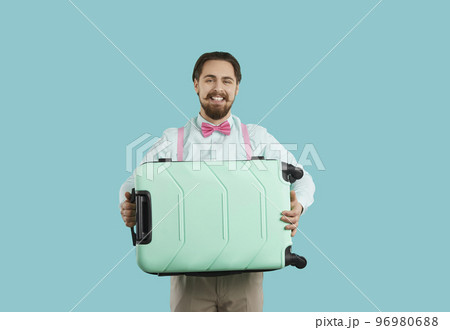 Happy man with suitcase excited about summer travel 96980688