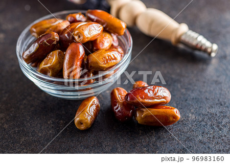 Dried dates fruit in bowl on black table. 96983160