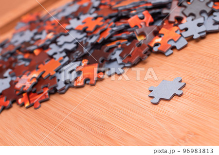 Mixed Jigsaw Puzzle Peaces on Wooden Table 96983813