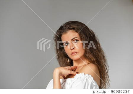 Pensive beautiful brunette girl in studio. Pensive beautiful brunette girl in studio. 96989257