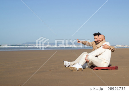 Gay man embracing boyfriend on beach 96991735