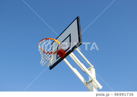Low angle shot of basketball hoop on sunny day 96991736