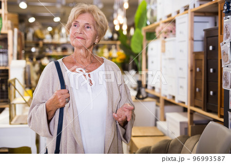 Active senior woman shopping at household store 96993587