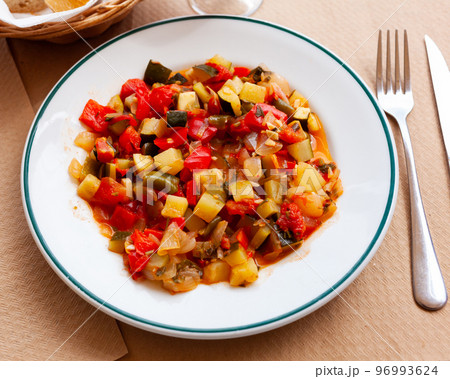 Plate of stewed vegetables on table. Vegetarian dish 96993624