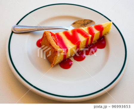 Classic cheesecake served with sweet berry sauce 96993653