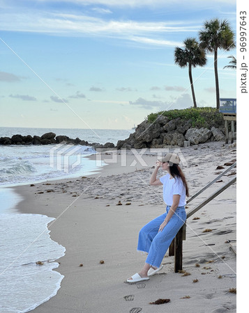 Young beautiful woman relax on the beach Young beautiful woman relax on the beach 96997643
