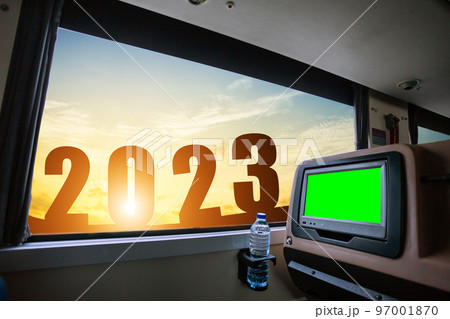 Happy New Year 2023,Inside of the bus which has LCD screen blank rear seat for entertainment with a bottle of water and window view of Beautiful landscape nature with sky cloud sunset,Figure tourism Happy New Year 2023,Inside of the bus which has LCD screen blank rear seat for entertainment with a bottle of water and window view of Beautiful landscape nature with sky cloud sunset,Figure tourism 97001870