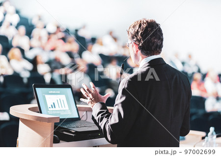 Speaker at Business Conference with Public Presentations. Audience at the conference hall. Entrepreneurship club. Rear view. Horisontal composition. Background blur. 97002699