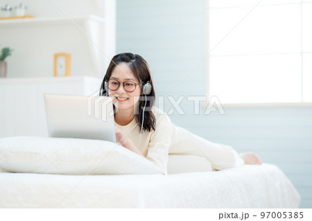 ノートパソコンで動画を視聴する若い女性 97005385