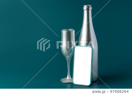 Beautiful picture of a bottle of champagne and glass on dark green background Beautiful picture of a bottle of champagne and glass on dark green background 97006264