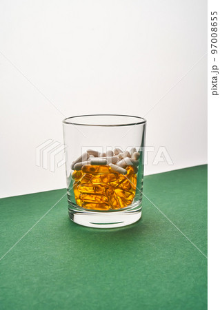 A glass with vitamins and other medical preparations. 97008655