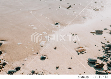 Abstract sea summer ocean sunset nature background. Small waves on golden water surface in motion blur with golden bokeh lights from sun. Holiday, vacation and recreational concept. Abstract sea summer ocean sunset nature background. Small waves on golden water surface in motion blur with golden bokeh lights from sun. Holiday, vacation and recreational concept. 97010718