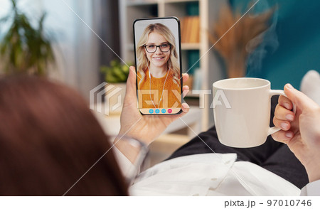 Video call with daughter using smartphone 97010746