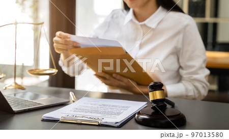 Lawyer woman working with paperwork on his desk in office workplace for consultant lawyer in office. Lawyer woman working with paperwork on his desk in office workplace for consultant lawyer in office. 97013580