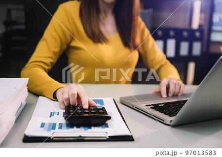 Business and financial concepts about office work. Analysts discuss business with a calculator as a tool. Business and financial concepts about office work. Analysts discuss business with a calculator as a tool. 97013583