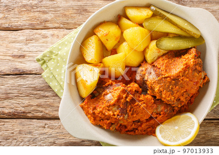 Macanese African Chicken Galinha a Africana close up on the pot. Horizontal top view Macanese African Chicken Galinha a Africana close up on the pot. Horizontal top view 97013933
