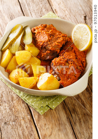 Galinha a Africana African Chicken from Macau served with potatoes, lemon and pickled cloiseup on the pot. Vertical Galinha a Africana African Chicken from Macau served with potatoes, lemon and pickled cloiseup on the pot. Vertical 97013940
