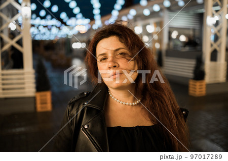 Cinematic night portrait of girl and lights in city with copy space - night life and youth concept Cinematic night portrait of girl and lights in city with copy space - night life and youth concept 97017289