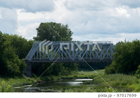 View of the steel railway bridge over a small river 97017699