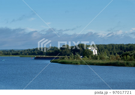 Cargo ships in the bay on a bright sunny day. Blue water and sky Cargo ships in the bay on a bright sunny day. Blue water and sky 97017721
