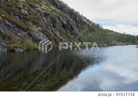 Steep shore over the lake. sunny summer landscape Steep shore over the lake. sunny summer landscape 97017738