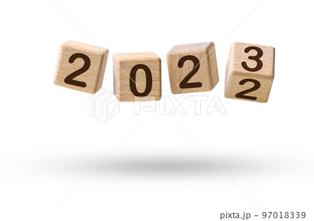 Happy new year concept. Wooden cube blocks changing from New year 2022 to 2023 flying over white 97018339