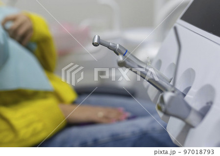 Different dental instruments and tools in a dentists office Different dental instruments and tools in a dentists office 97018793