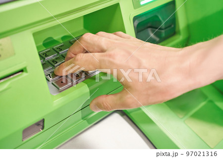 Man enter pin code at ATM security keyboard. Service people hand. Credit service 97021316