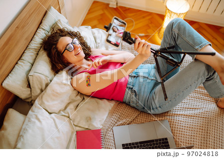 Woman blogger videotapes her vlog at home and speaking about Vaccine for covid-19. 97024818