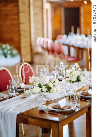 Beautiful table setting for a party, wedding reception or other festive event. Banquet setting, glasses, plates. 97027471